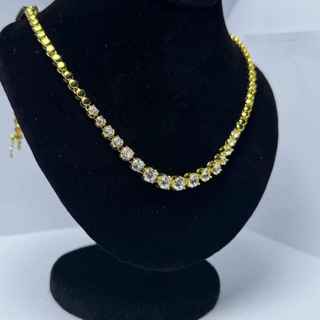 Golden necklace with white stones